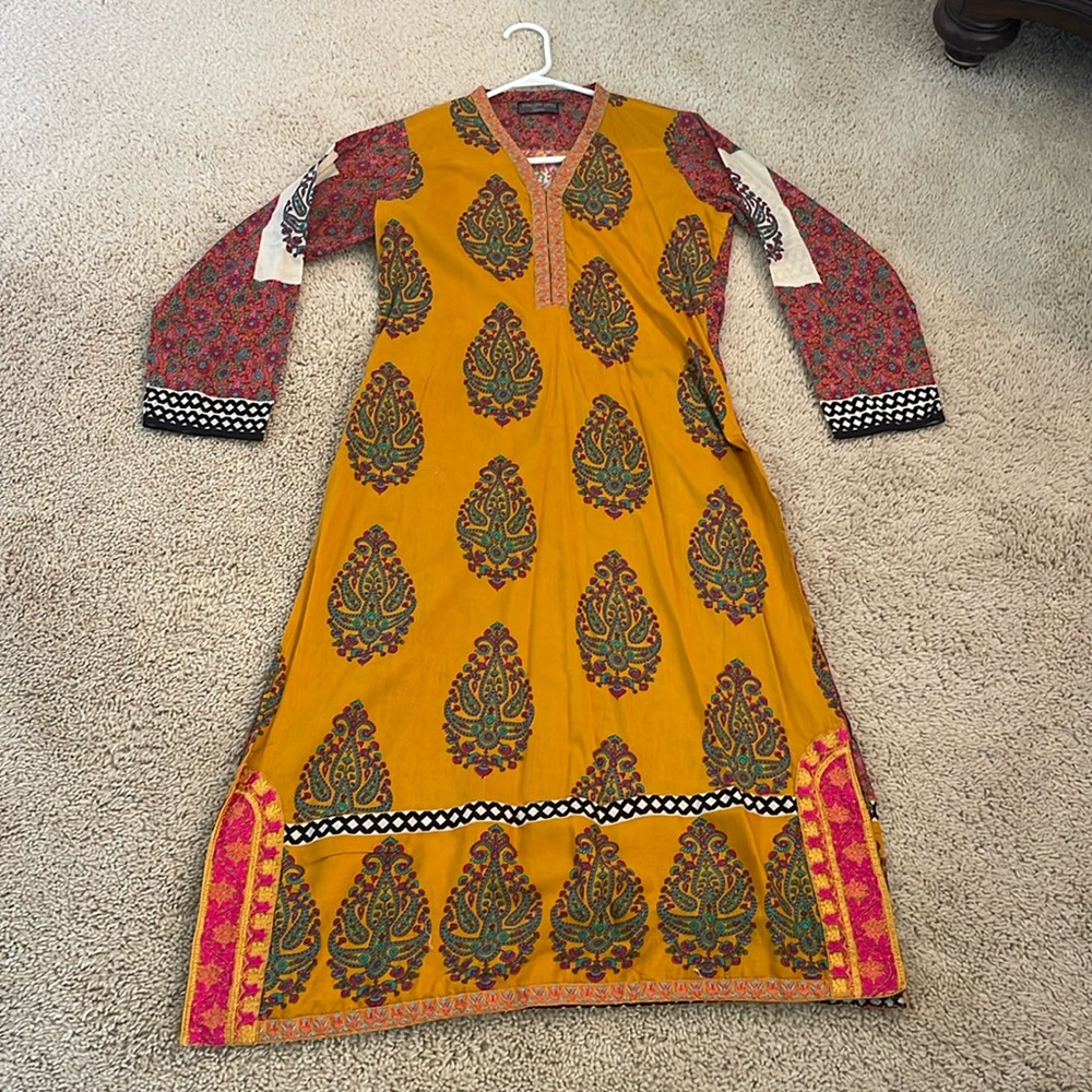 Pakistani Indian printed kurta in mustard color with some embroidery.